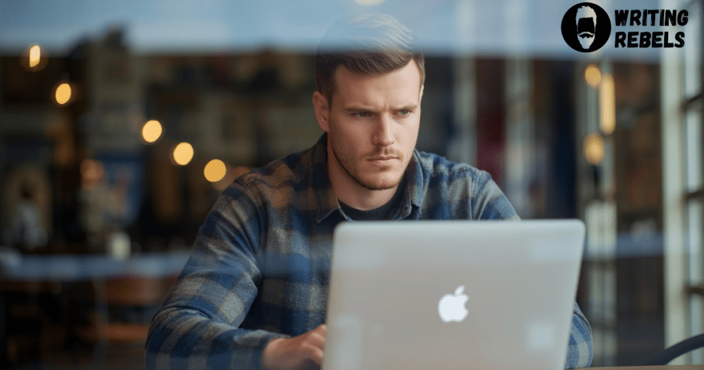 man typing on macbook